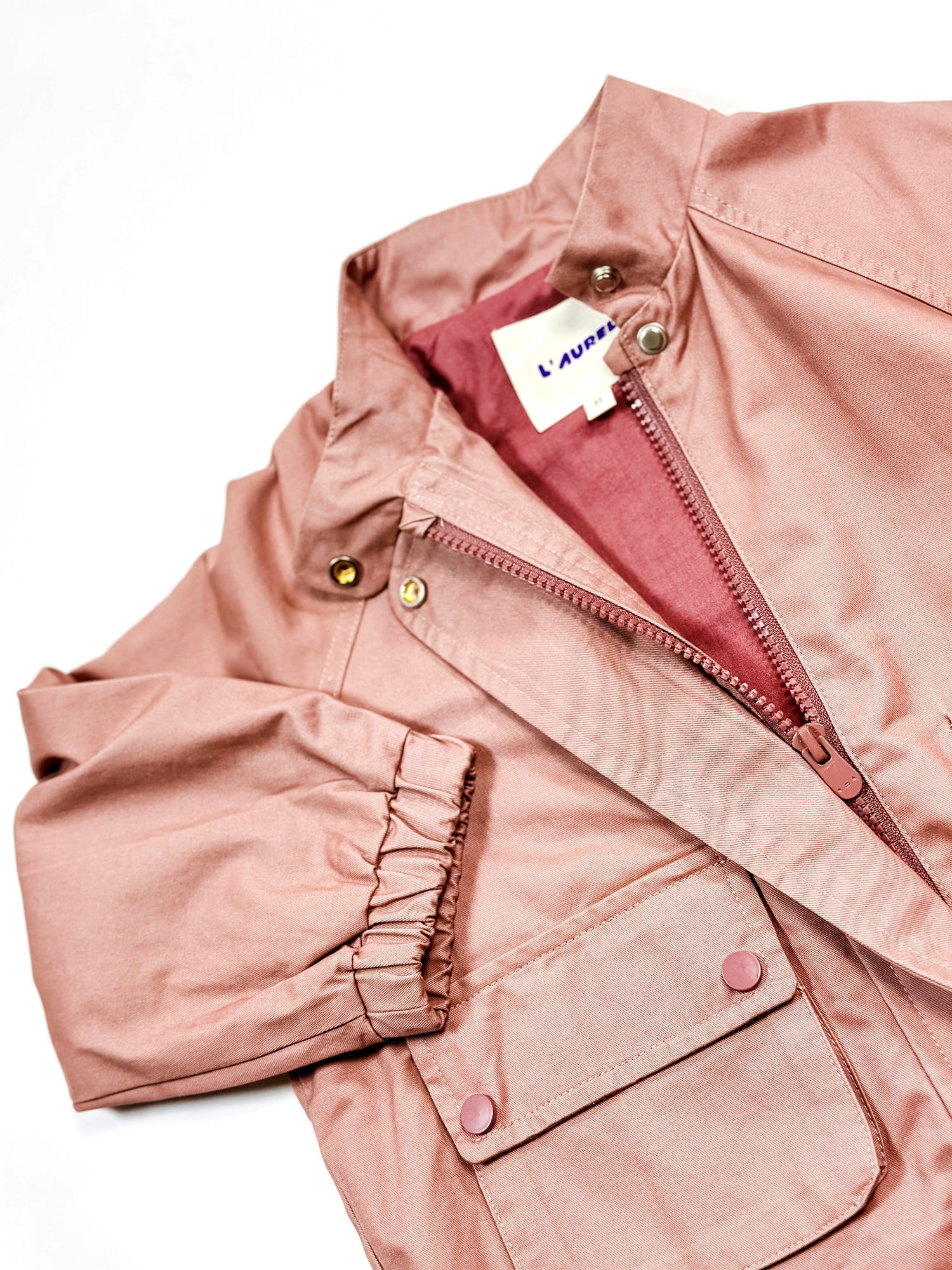 Pink jacket with a brand label on a white background by Laurel