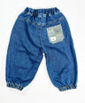 Blue denim baby pants with a decorative pocket on a white background