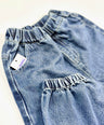 Blue baggy jeans with a visible brand tag on a light background