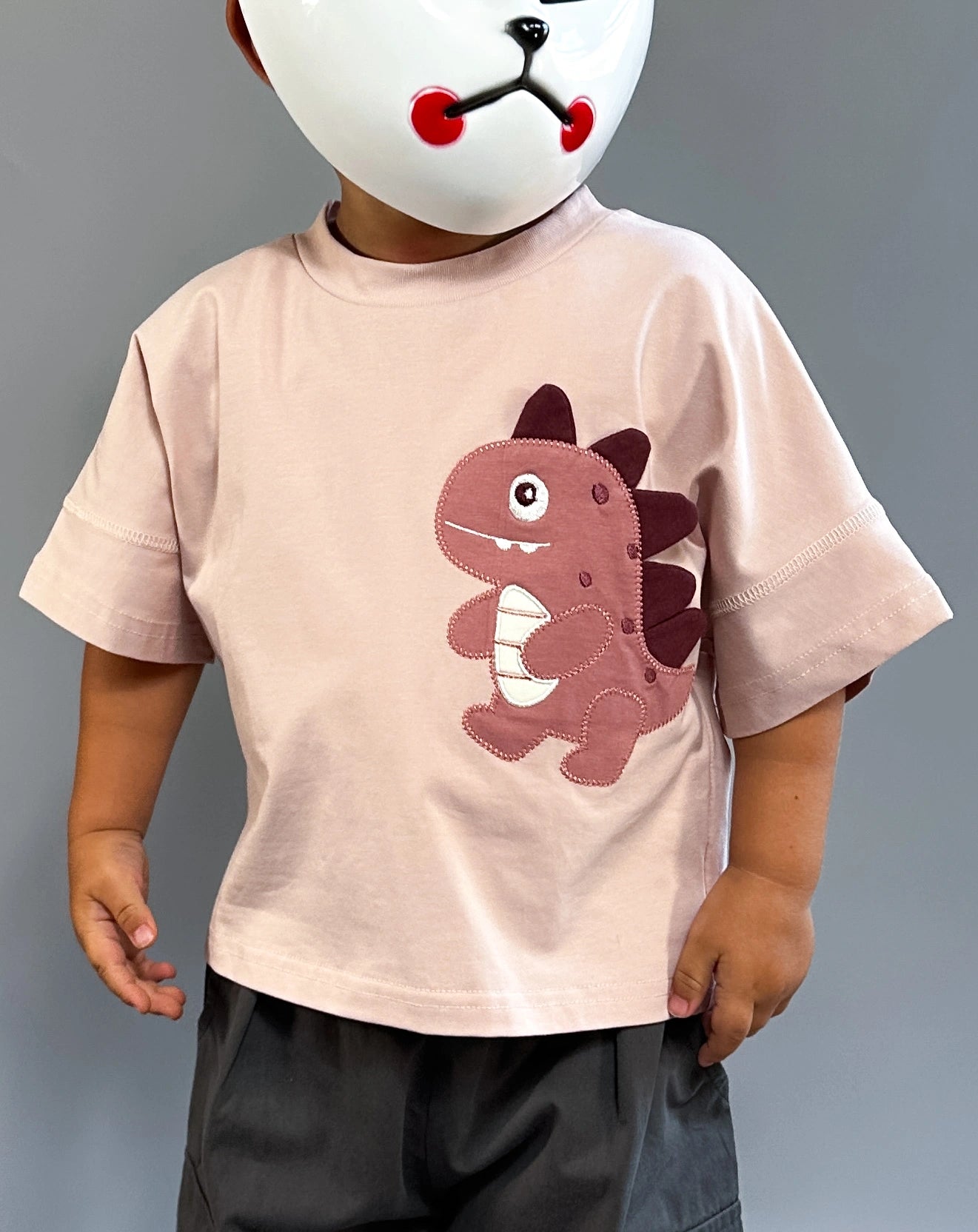 Soft pink oversized toddler t-shirt with a cute dinosaur patch on the chest – playful and comfy everyday style by Little Aurel