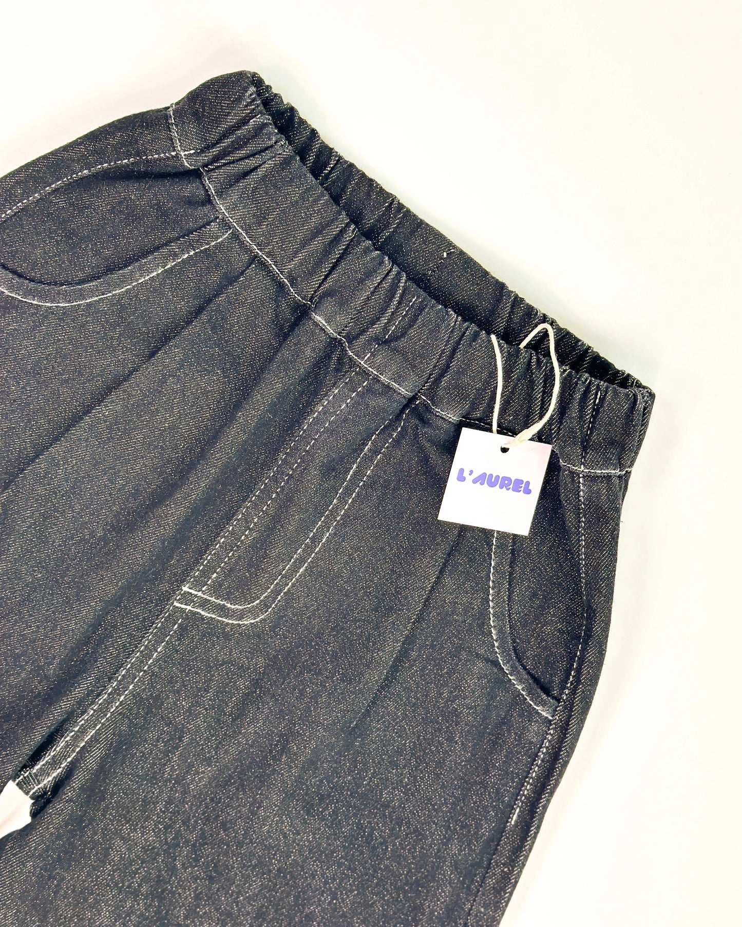 Dark wash easy-fit denim pants for kids with elastic waistband from Little Aurel.