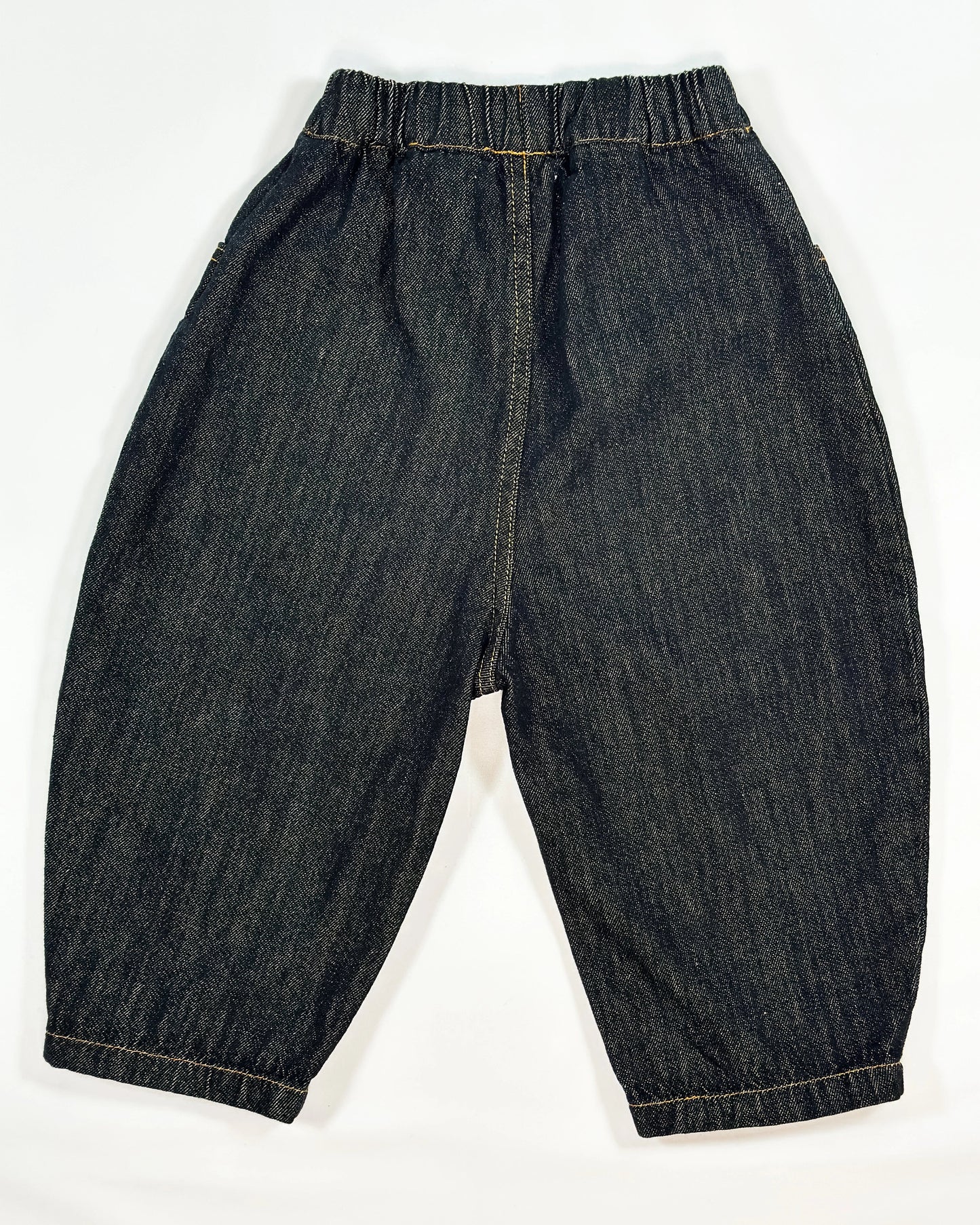 Black barrel-fit denim pants for toddler boys with contrast yellow stitching and wide relaxed cut by Little Aurel.