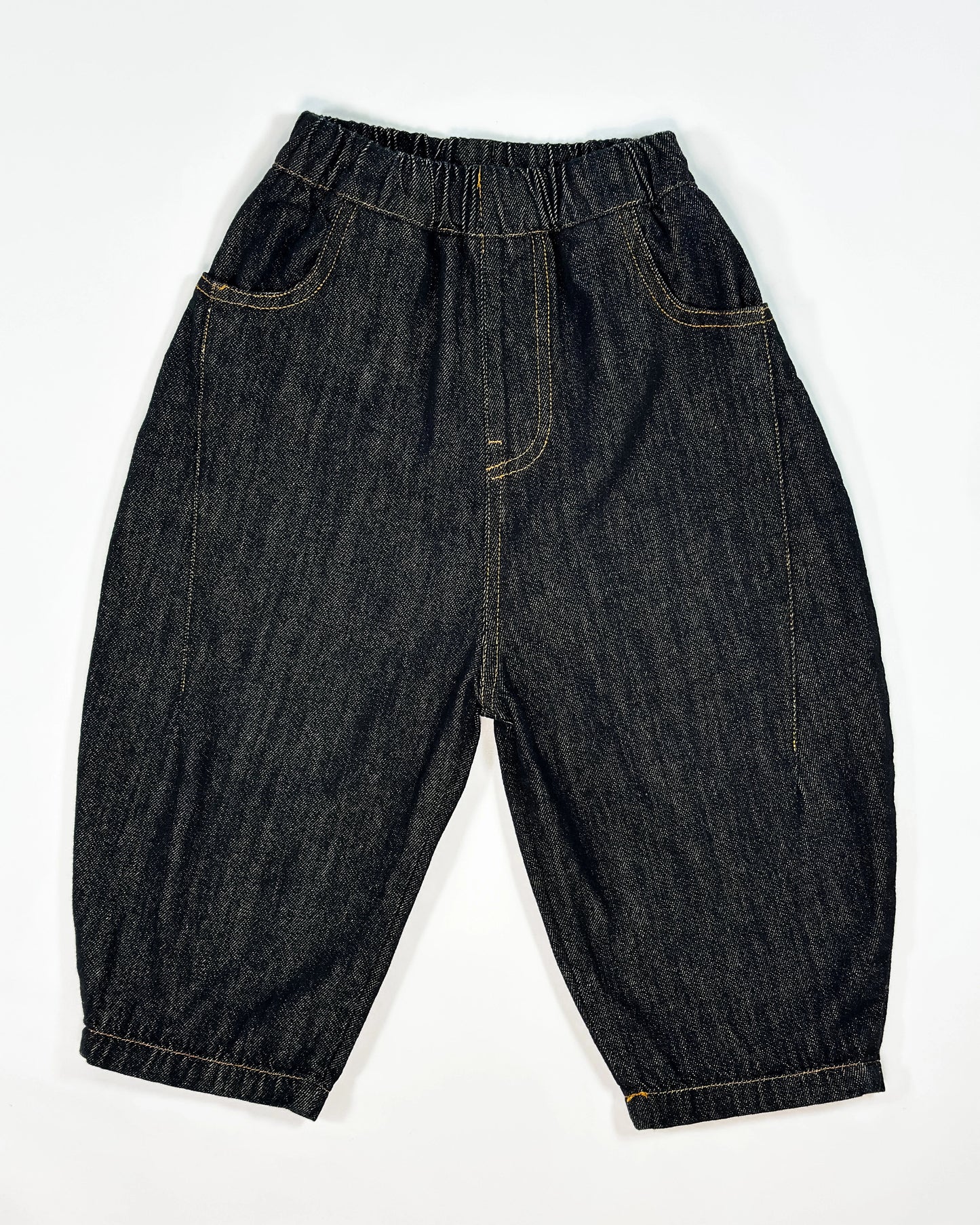 Black barrel-fit denim pants for toddler boys with contrast yellow stitching and wide relaxed cut by Little Aurel.