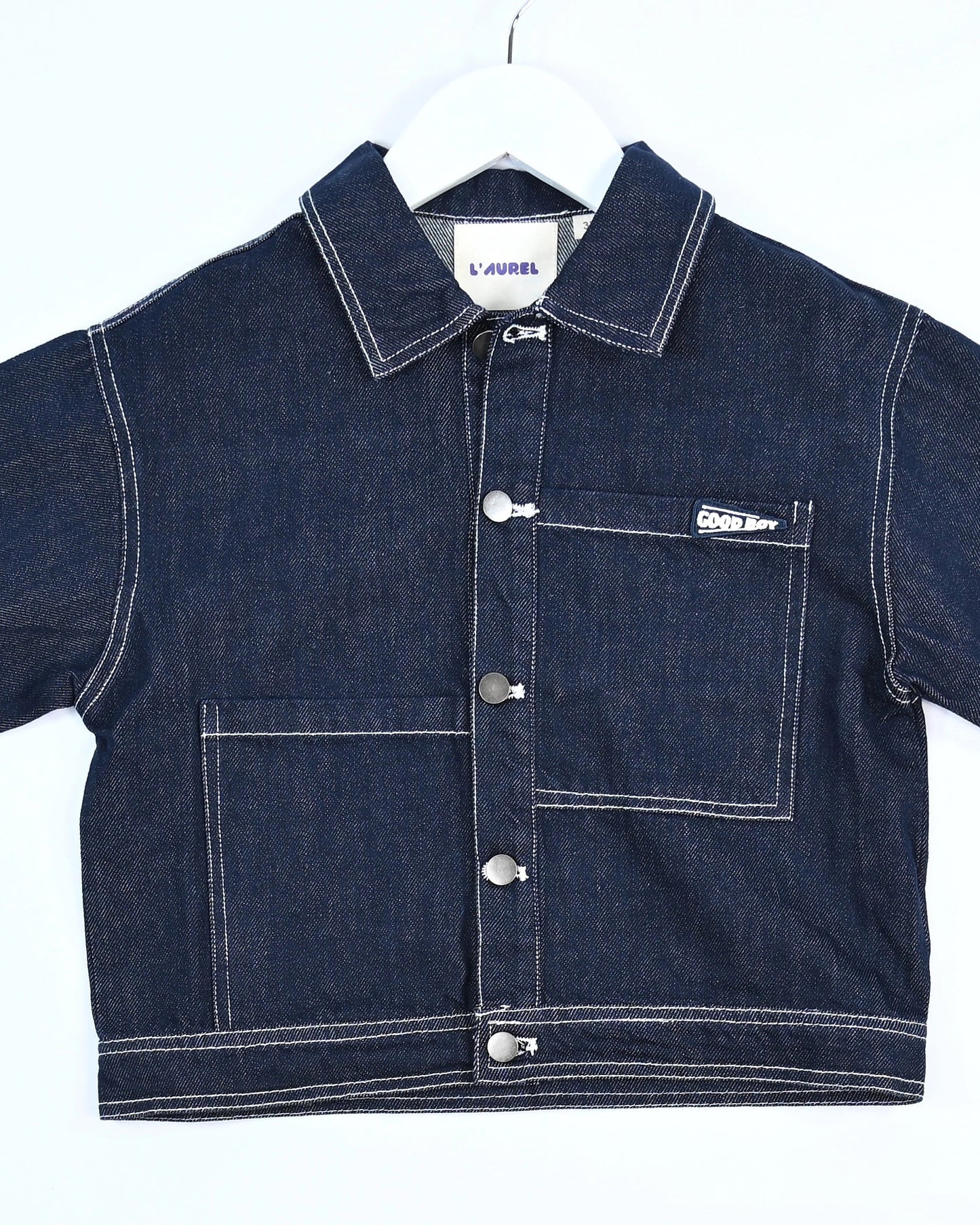 Dark blue denim jacket for toddler boys with front pocket details, silver buttons, and “Good Boy” embroidery by Little Aurel.