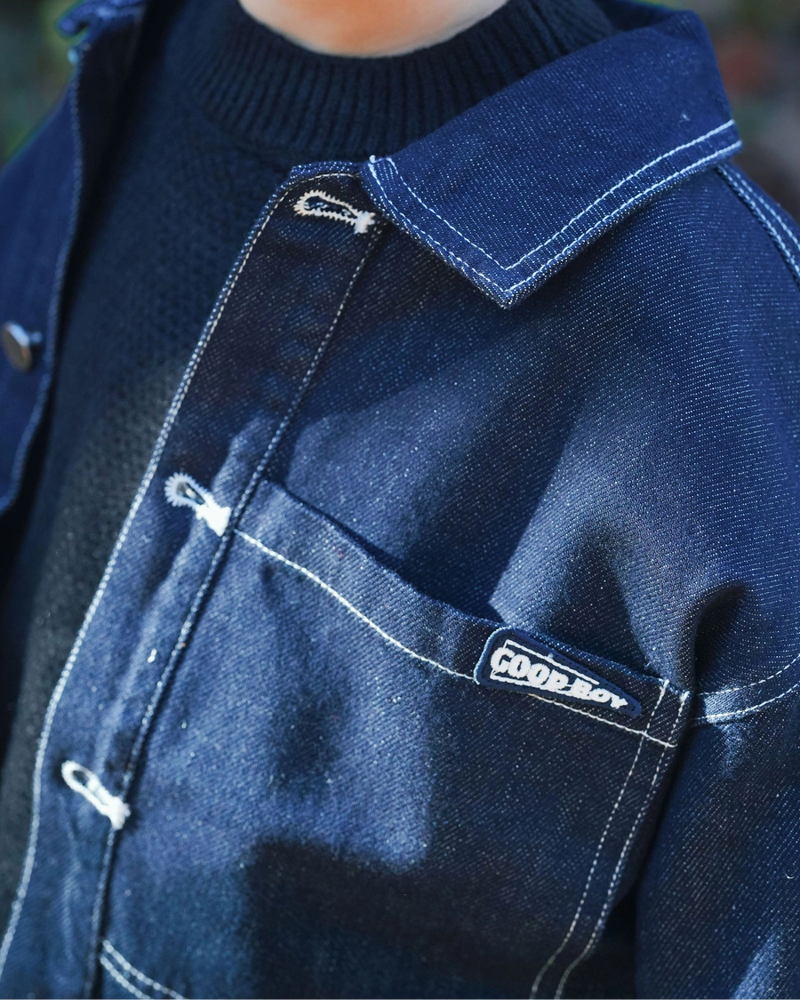 Dark blue denim jacket for toddler boys with front pocket details, silver buttons, and “Good Boy” embroidery by Little Aurel.