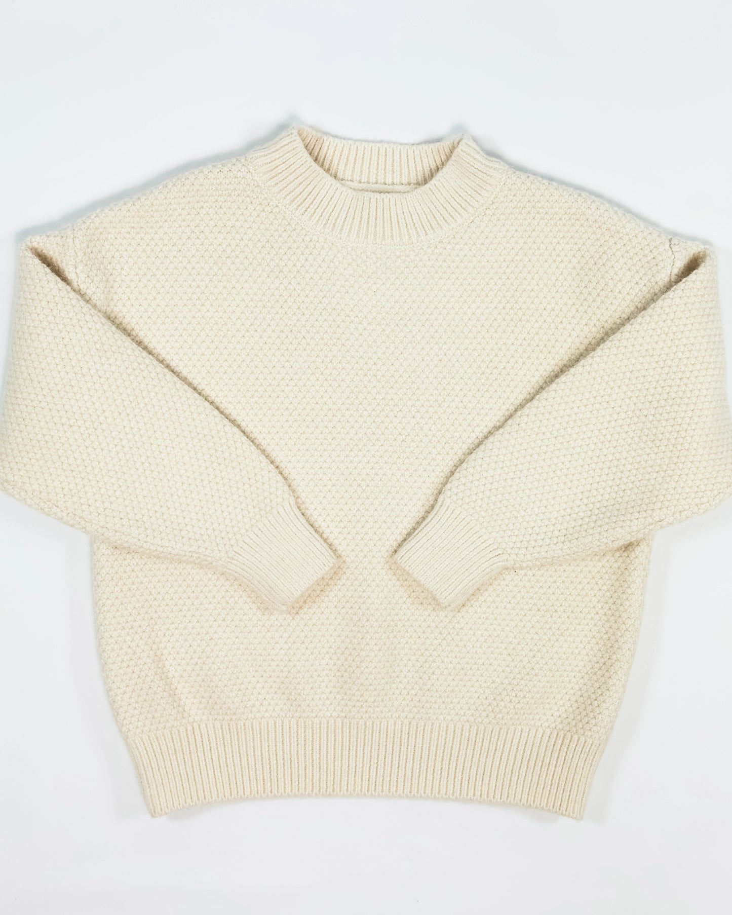 Cream knit pullover for toddler boys by Little Aurel.