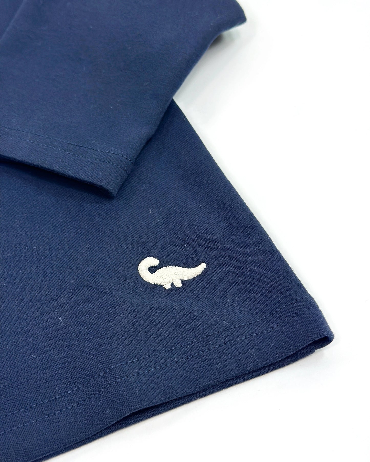 Loose-fit longsleeve shirt for kids in navy blue with small dinosaur embroidery