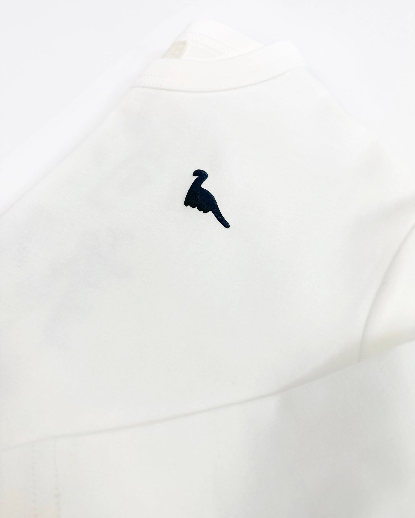 Oversized graphic longsleeve for kids in white with back print and small dinosaur detail