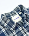 Oversized plaid blouse for toddler boys in navy and grey with front pocket and button-down design by Little Aurel.
