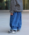 Little Aurel Blue Signature Jeans on model with black white striped knit Pullover.