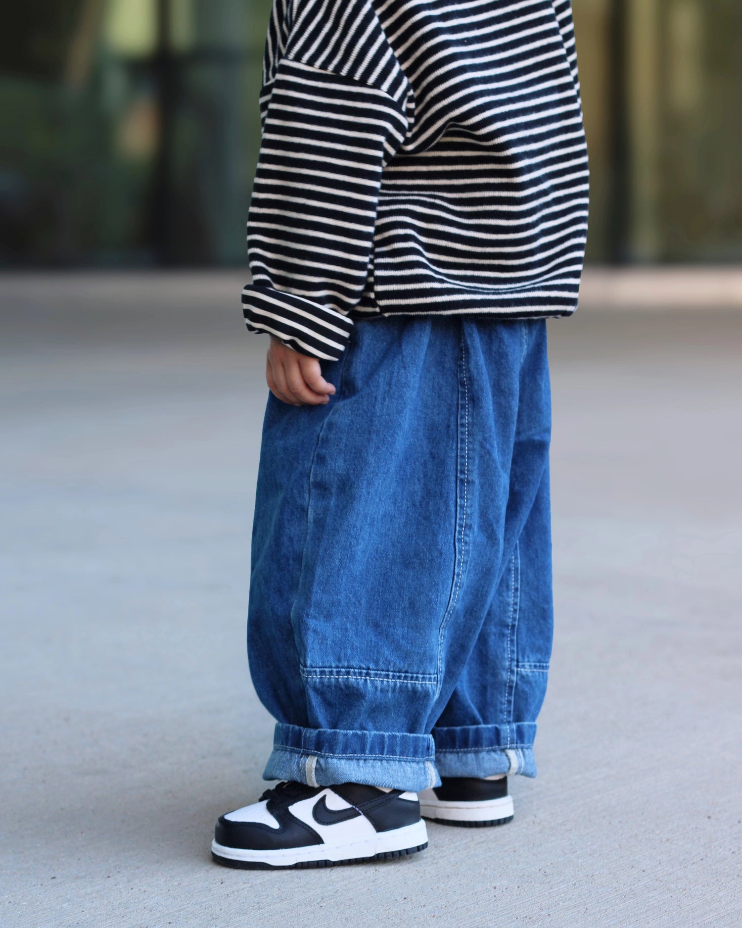 Little Aurel Blue Signature Jeans on model with black white striped knit Pullover.