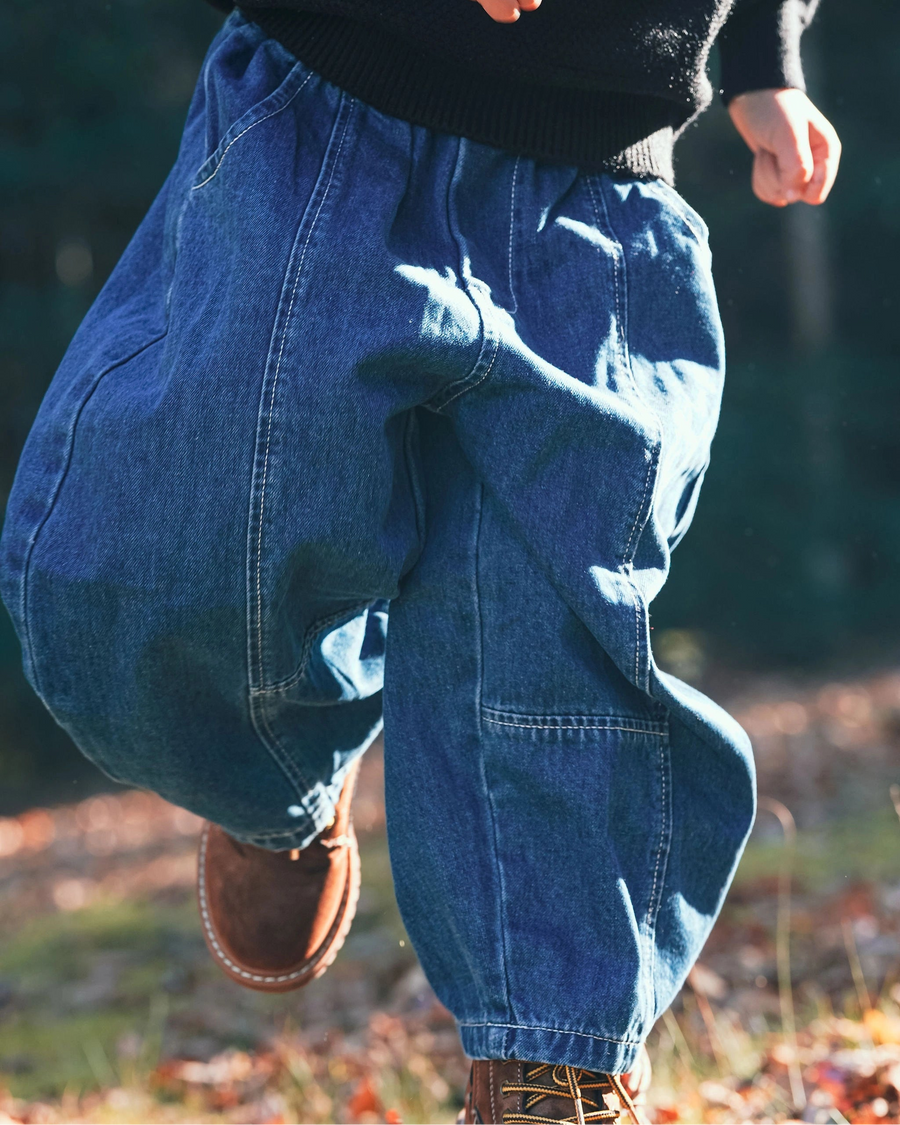 Little Aurel Blue Signature Jeans on model with black knit Pullover.