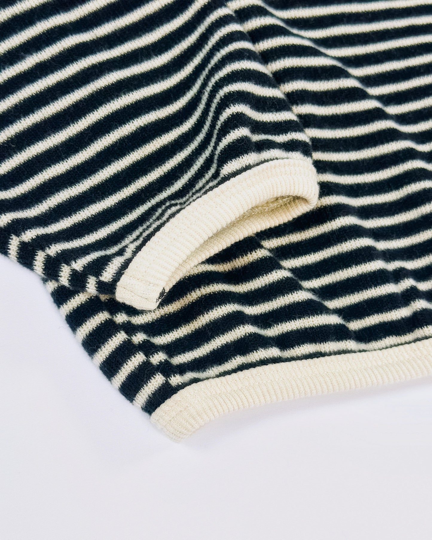 Black and white striped knit pullover for toddler boys with cream neckline and cuffs by Little Aurel