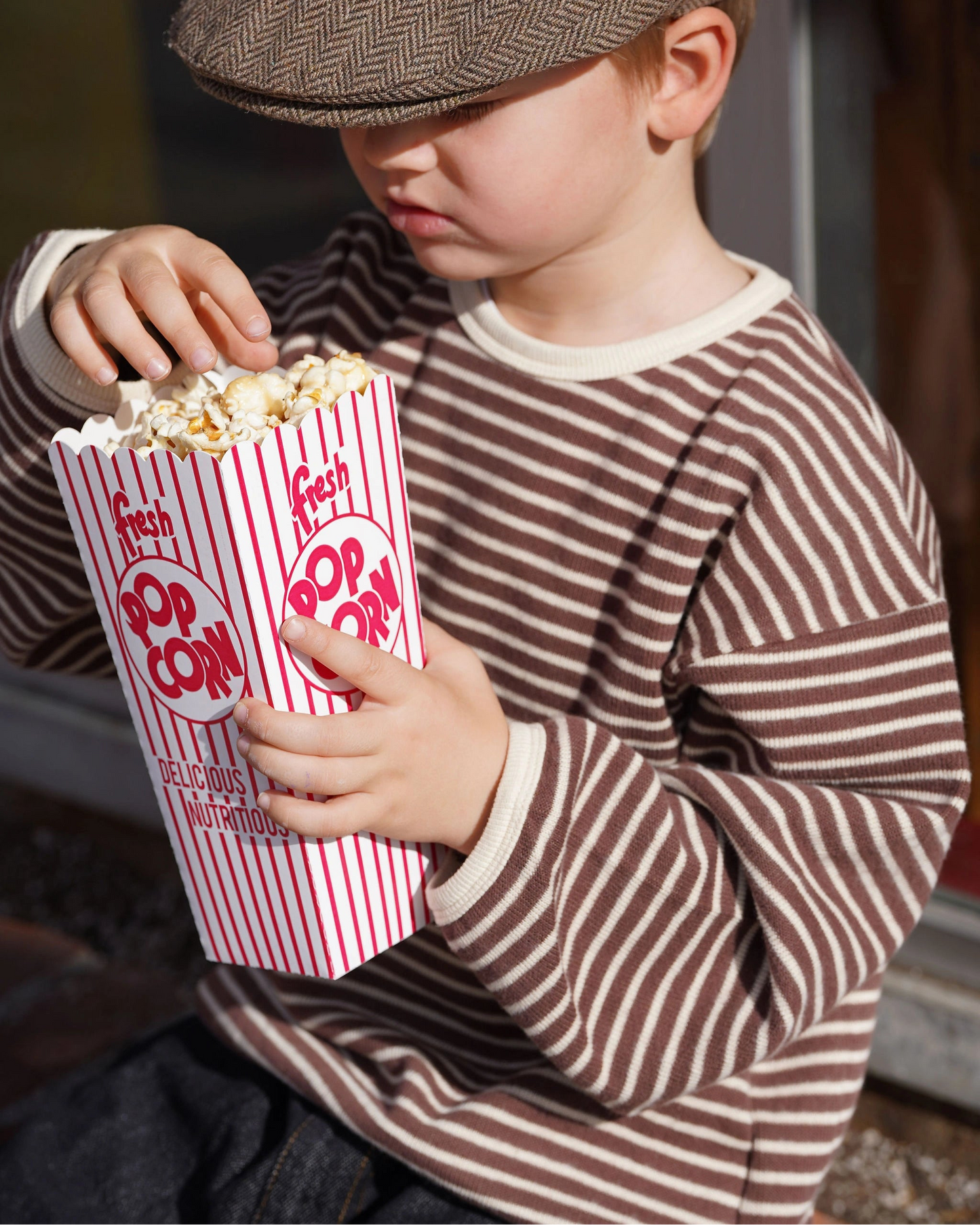 Brown and white striped knit pullover for toddler boys with cream neckline and cuffs by Little Aurel