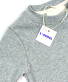 Gray sweater with a 'L'Aurel' tag on a white background