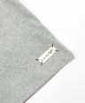 Gray fabric with a 'lucky' label on a white background by L'aurel